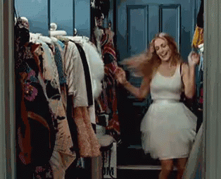 Carrie Bradshaw dancing around in her walk-in closet.