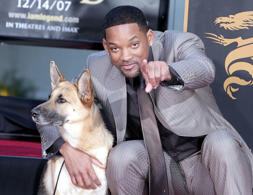 Will Smith poses on the red carpet with the dog from I Am Legend