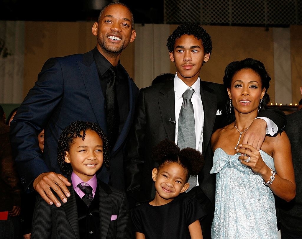 Will poses at an event with his three children and wife Jada