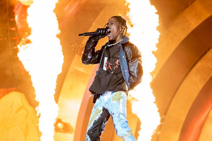 Travis performing onstage with pyrotechnics behind him
