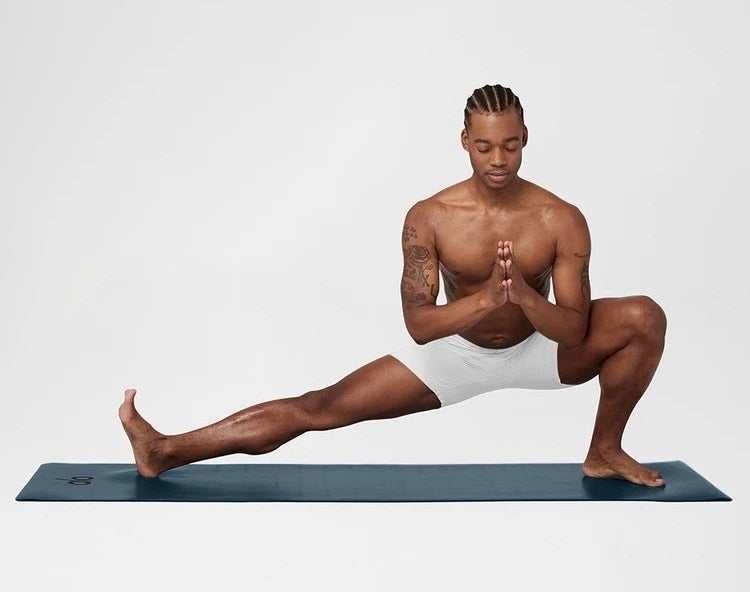 model stretching on yoga mat