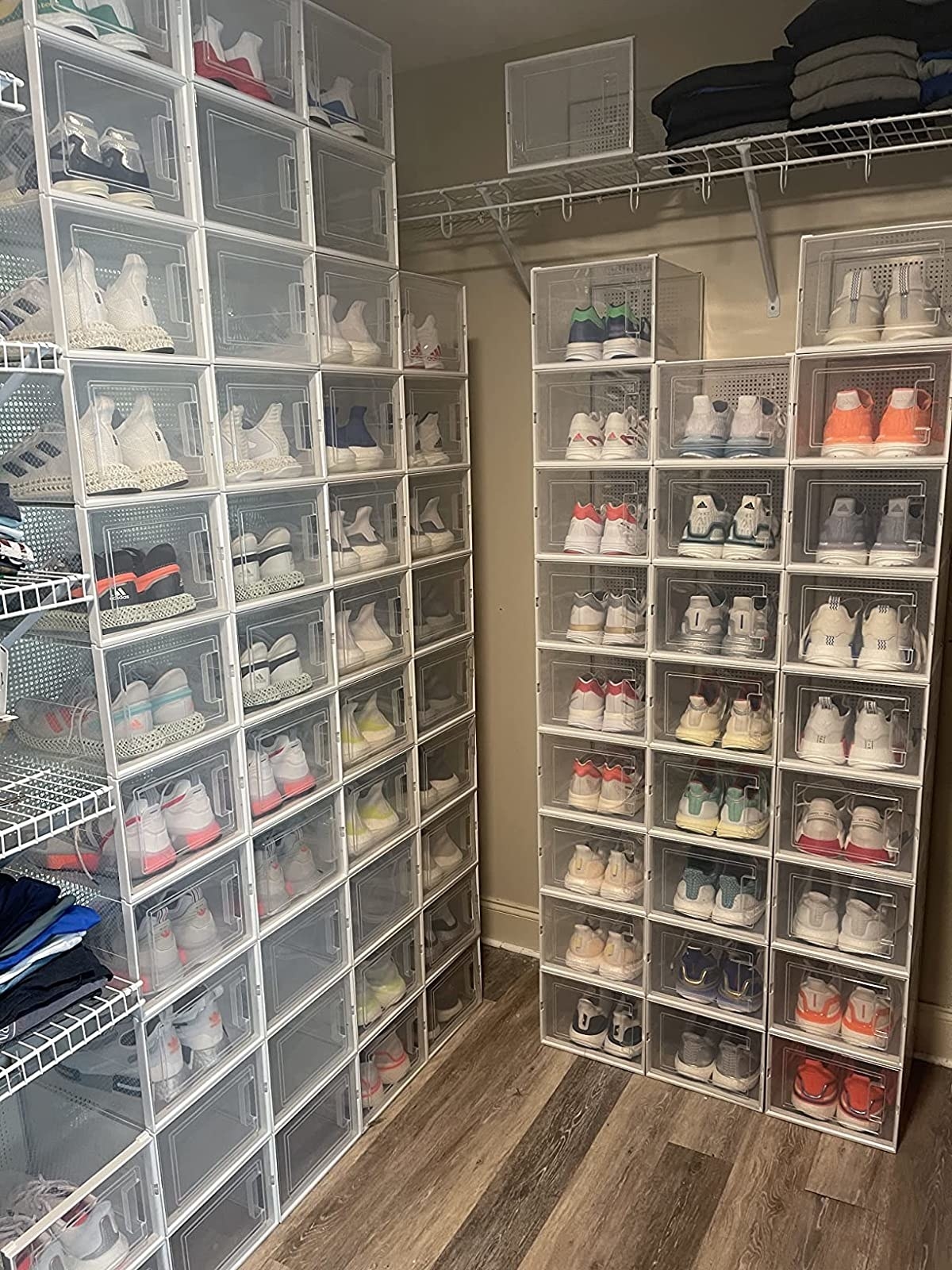 A reviewer photo of the inside of a closet with two walls of sneakers inside of the clear drop front shoeboxes