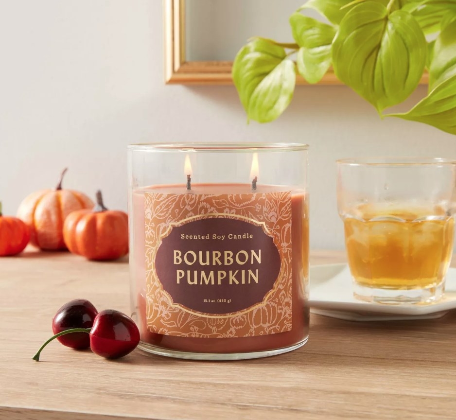 A bourbon pumpkin candle atop a table