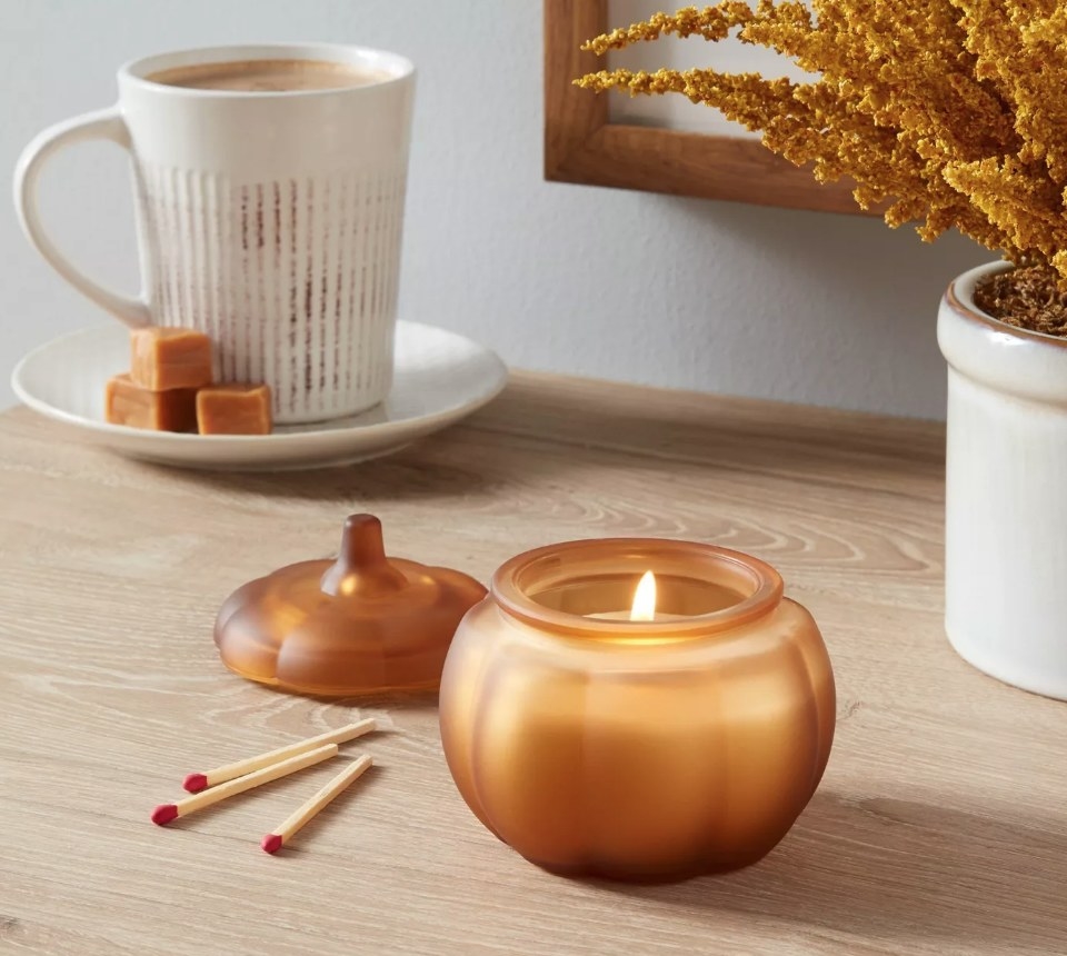 A pumpkin caramel latte honey orange scented candle in a pumpkin votive
