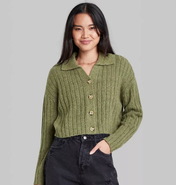 A model wearing a sage green button-up ribbed cropped cardigan
