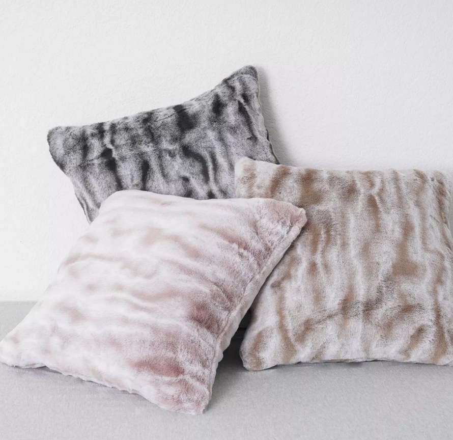 A tan, pink, and brown faux fur ombre throw pillow