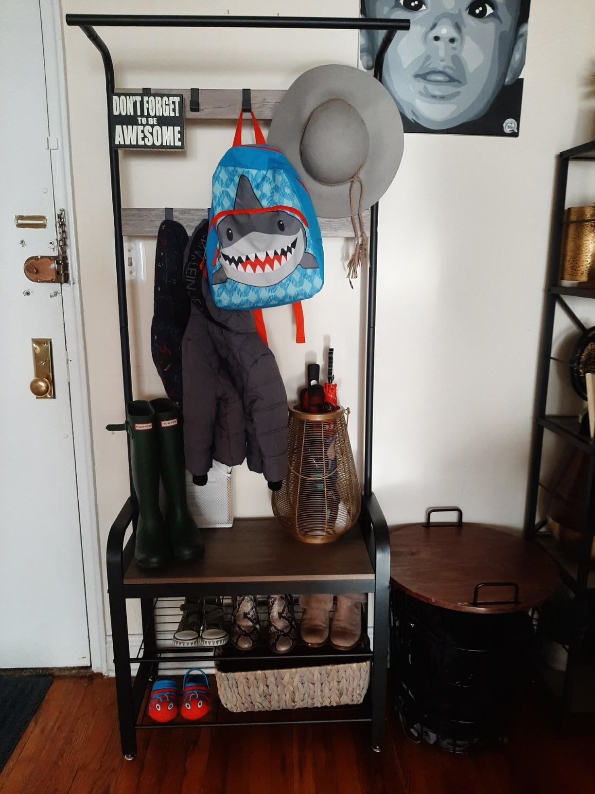 a reviewer photograph  of the introduction  mode   organizer adjacent   a beforehand   doorway  with a child's backpack, shoes, jackets, hats and different   miscellaneous items connected  it