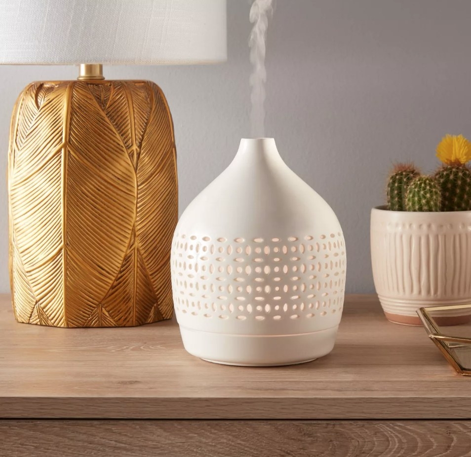 A cream ceramic diffuser atop a table