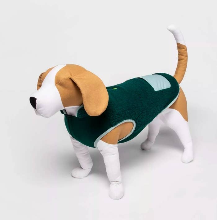 A stuffed dog model wearing the green sherpa vest