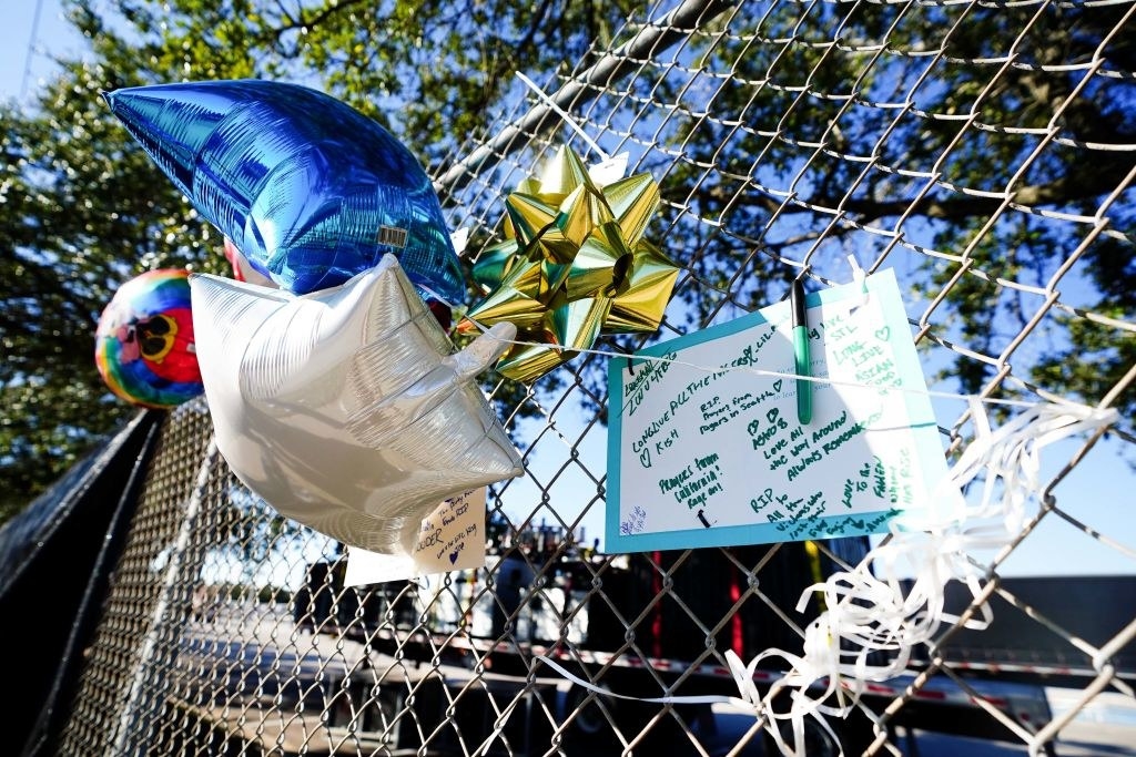 Notes, pillows, and other items attached to a fence