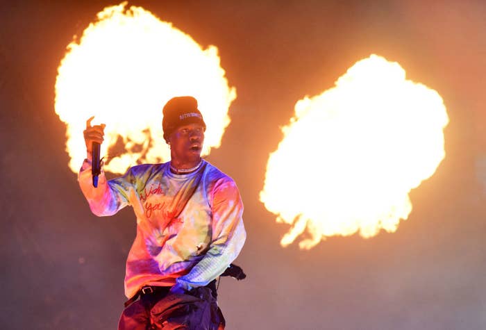 Travis Scott onstage with flashing lights in the background