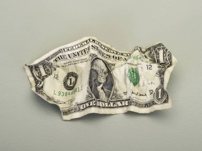 A crumpled-up dollar bill