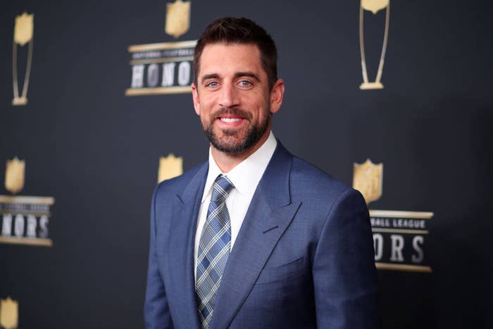 Aaron Rodgers smiling on the red carpet