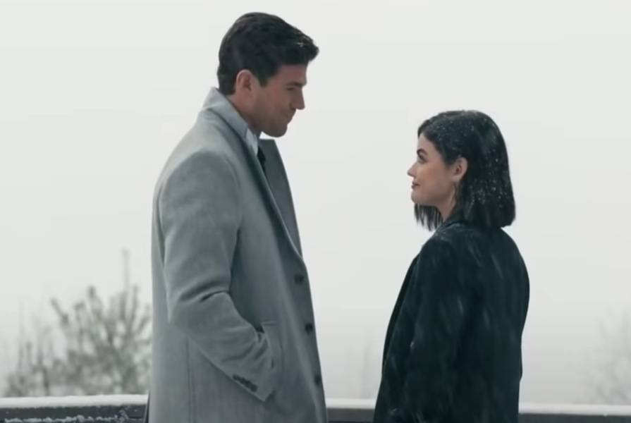 Joshua and Lucy wearing coats outdoors and looking at each other