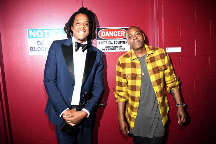 Jay-Z and Dave Chappelle pose for a photo together backstage