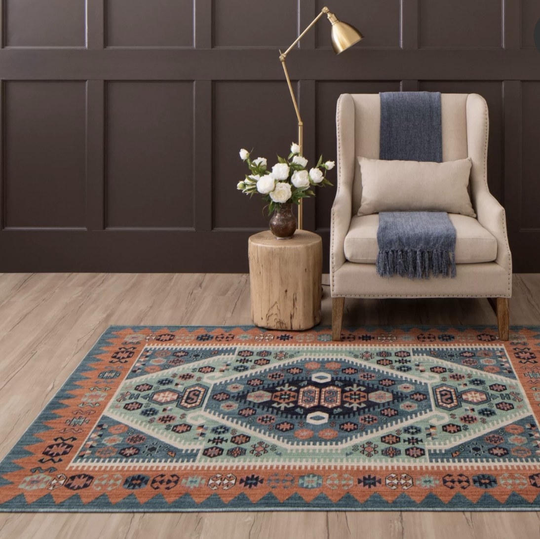 The blue and orange toned rug has diamond shaped and patterned layers