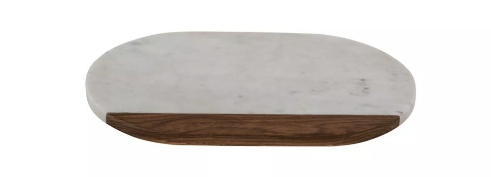 The oval platter is mostly white marble with a small sliver of dark wood on the bottom