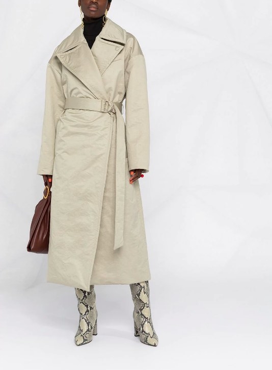 Model wearing the cream-colored trenchcoat with a tie waist