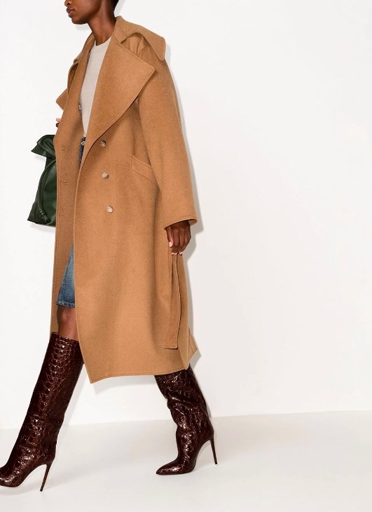 Model wearing the brown boots with a jean skirt and long coat