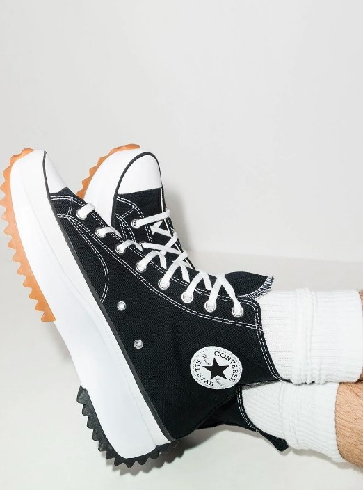 The black high-top Converse sneakers