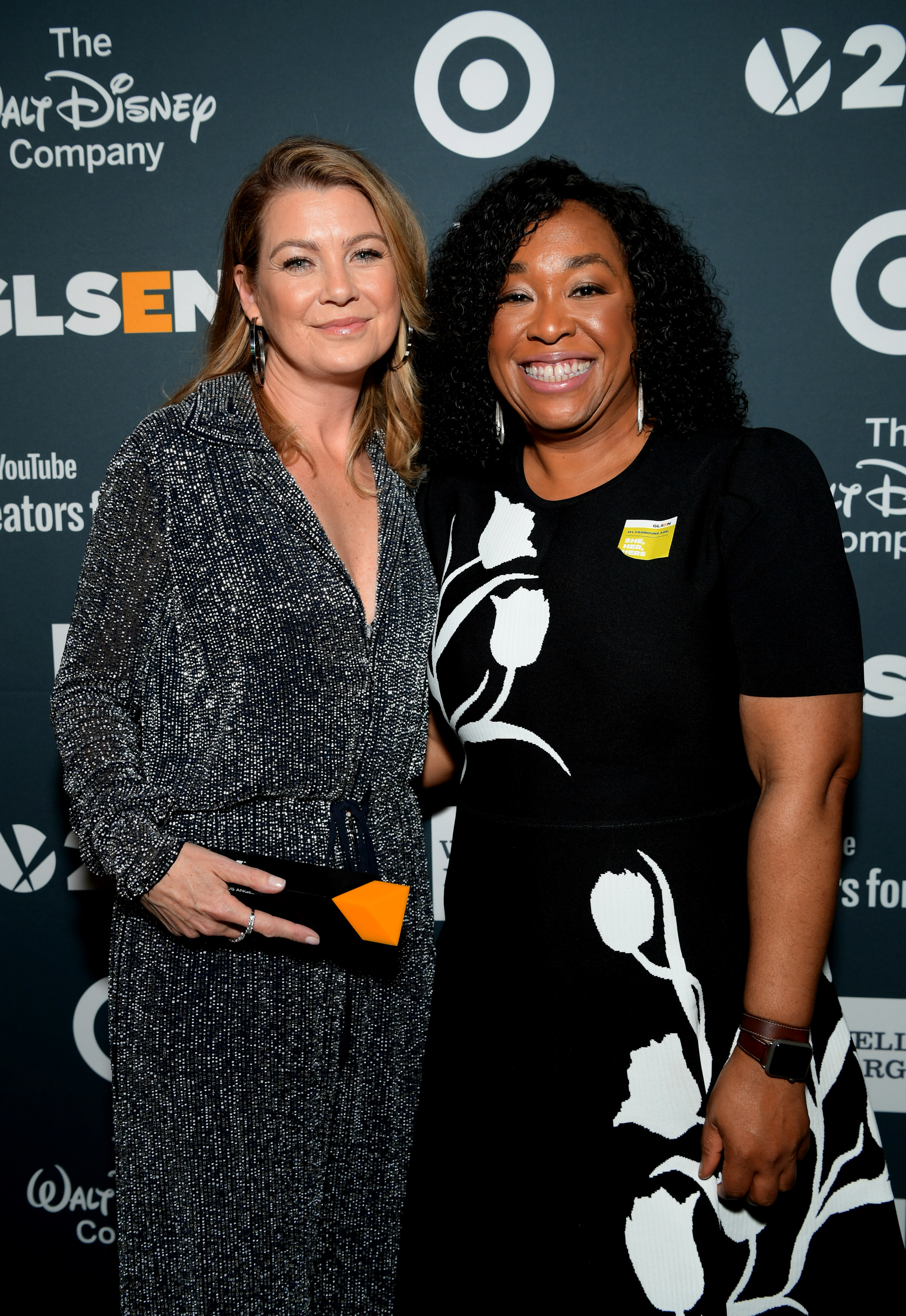 Shonda smiles on a red carpet with Ellen Pompeo