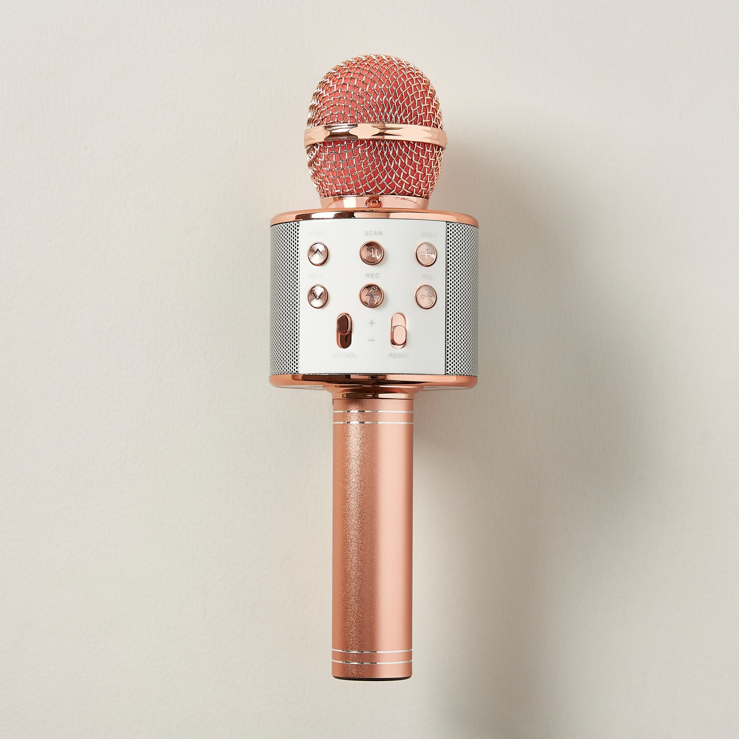 A cordless microphone on a plain background