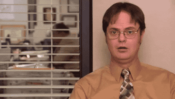 Dwight Schrute going from a blank stare to a giggle