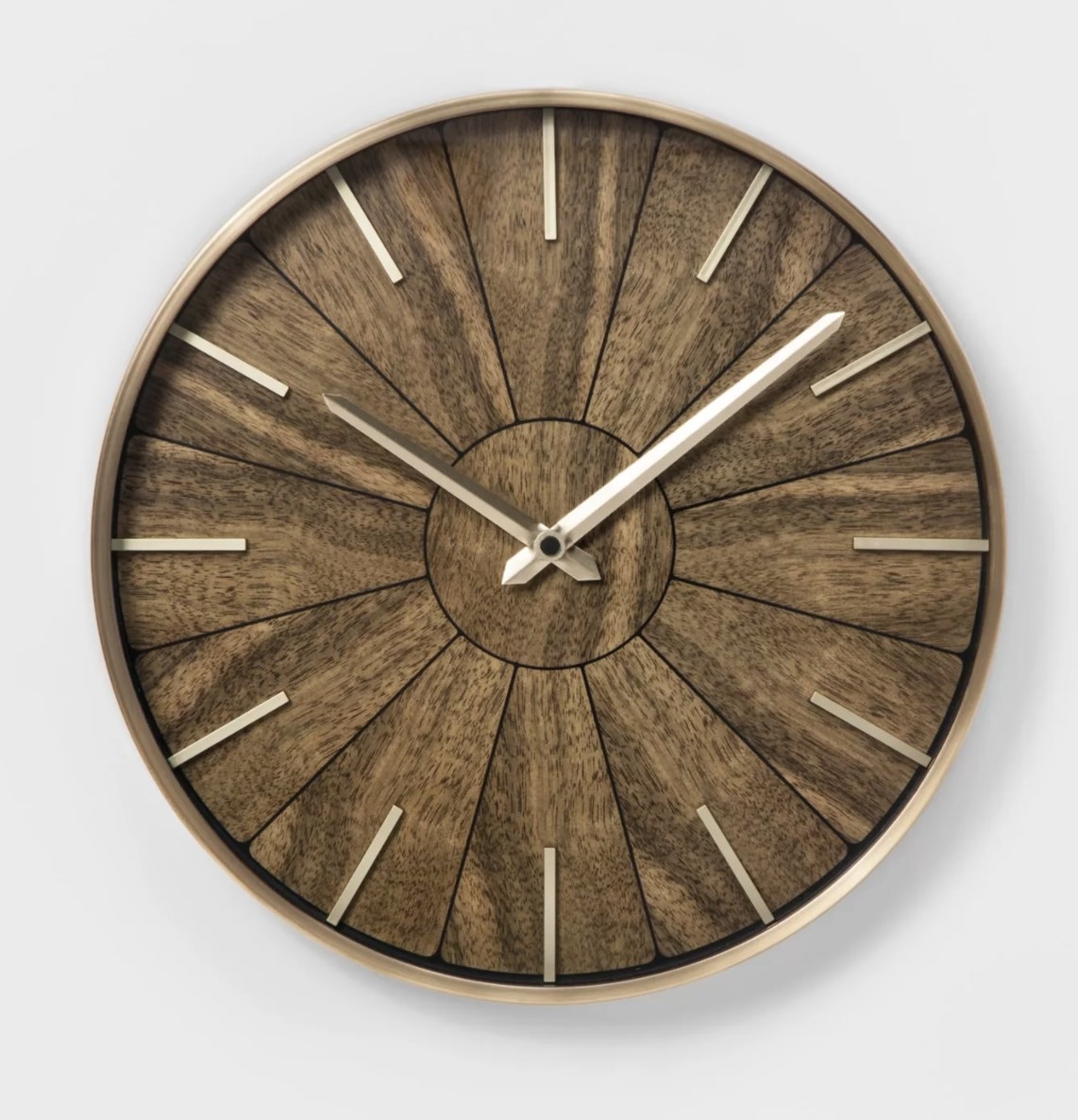 The clock has a wood pattern and round metal brass frame with brass hands and tick marks