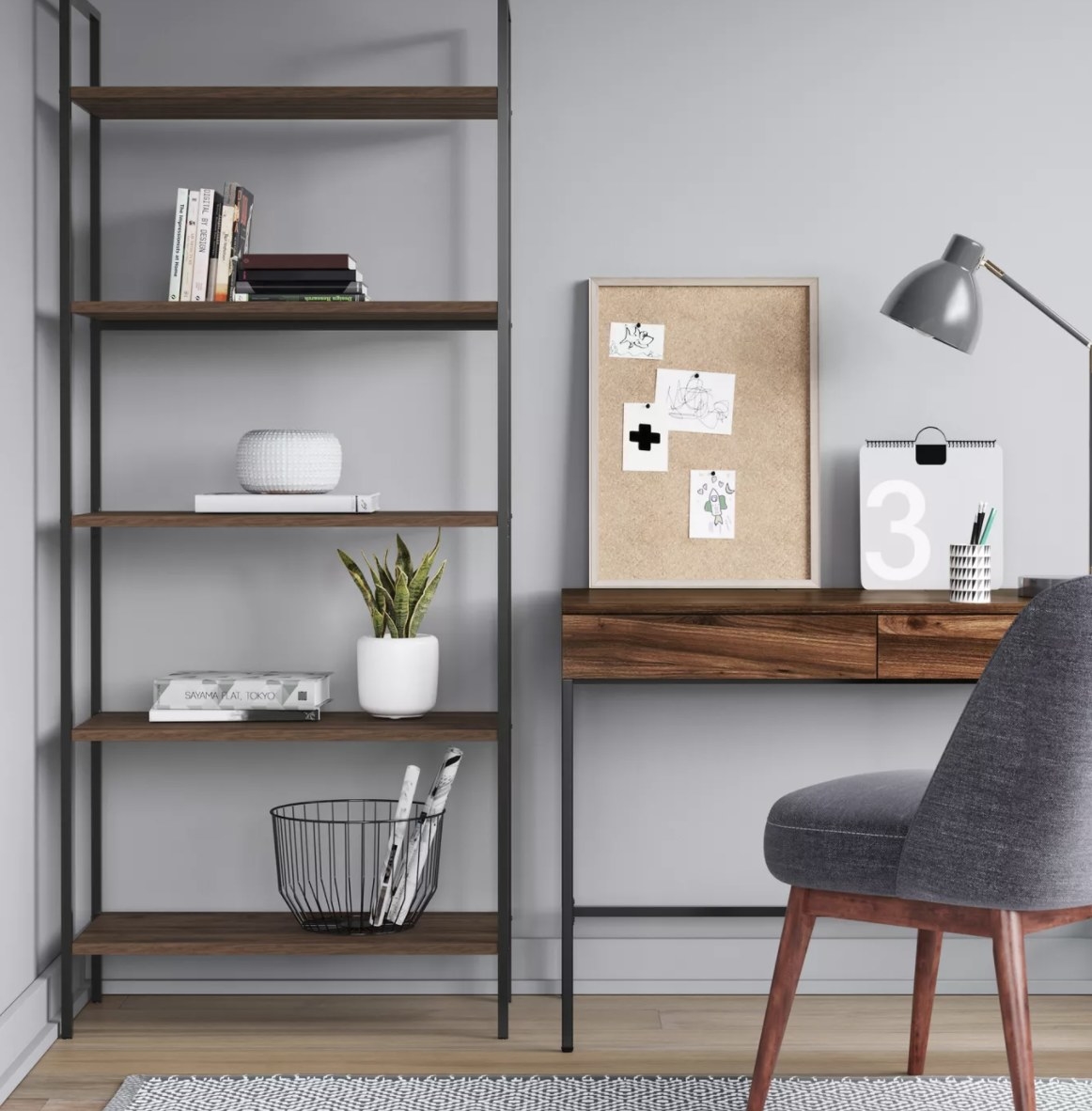 The black metal frame and dark brown shelves are holding books, plants and other decor in a home office