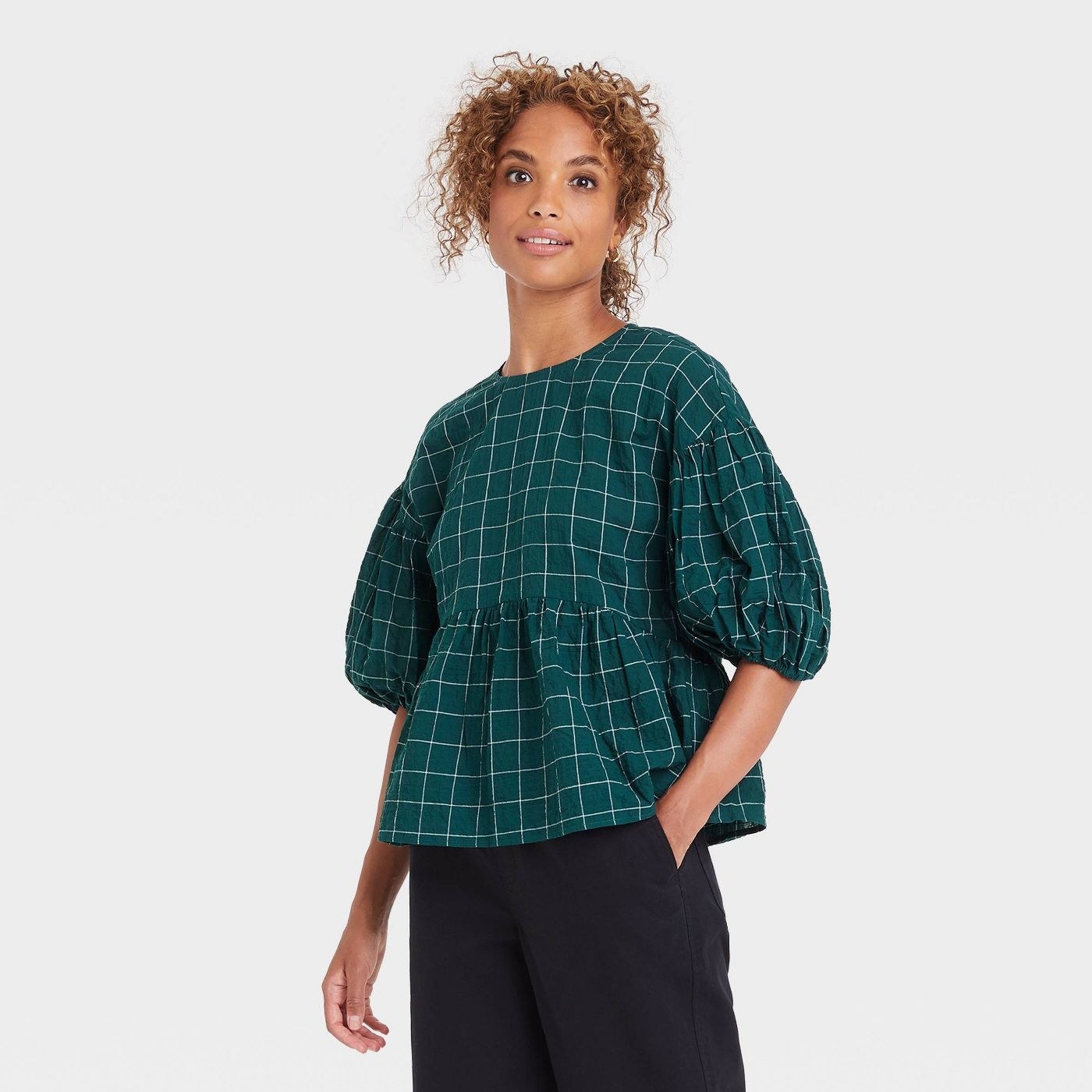 A green plaid blouse with puff sleeves