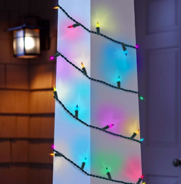 The multicolored lights strung around a front porch pillar