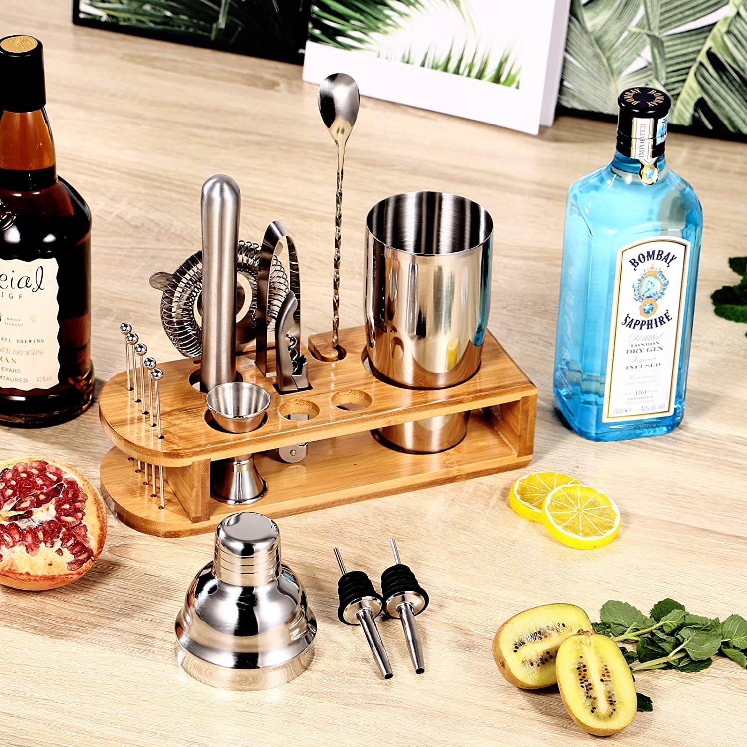 a 15 piece bartending set next to bottles of alcohol and fresh fruit