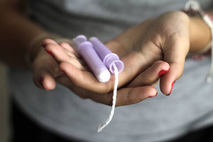 Close up of a woman holding tampons