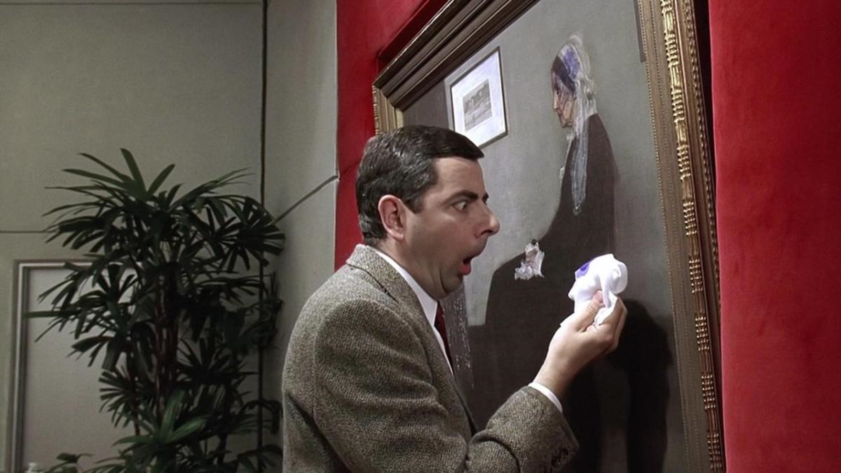 A man wiping a historical painting and looking at the wipe in shock.