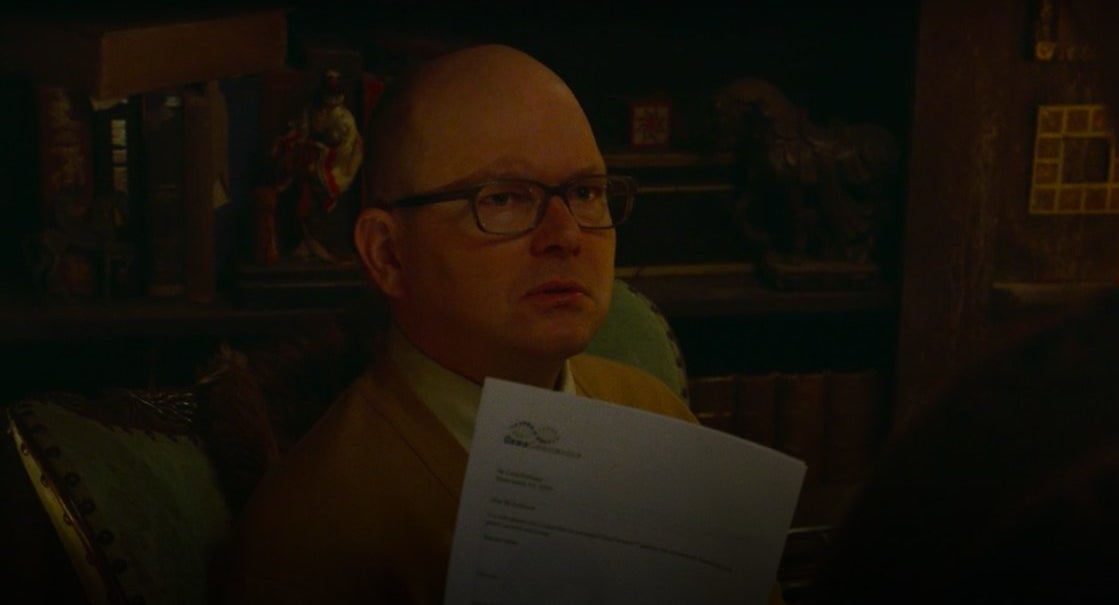 Colin Robinson holding up his ancestry report in &quot;What We Do in the Shadows&quot;