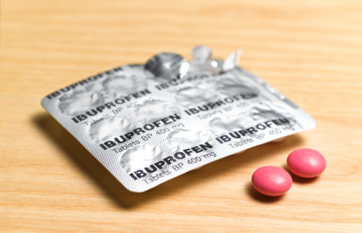 Ibuprofen red tablets sitting on a table