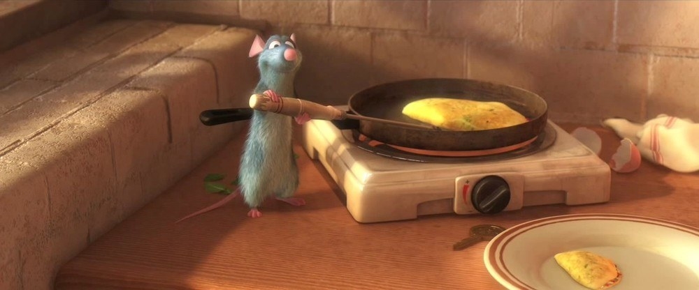 A cartoon rat serving up an omelet from a pan