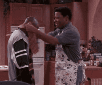 Frank teaching Hakeem how to put on a tie.