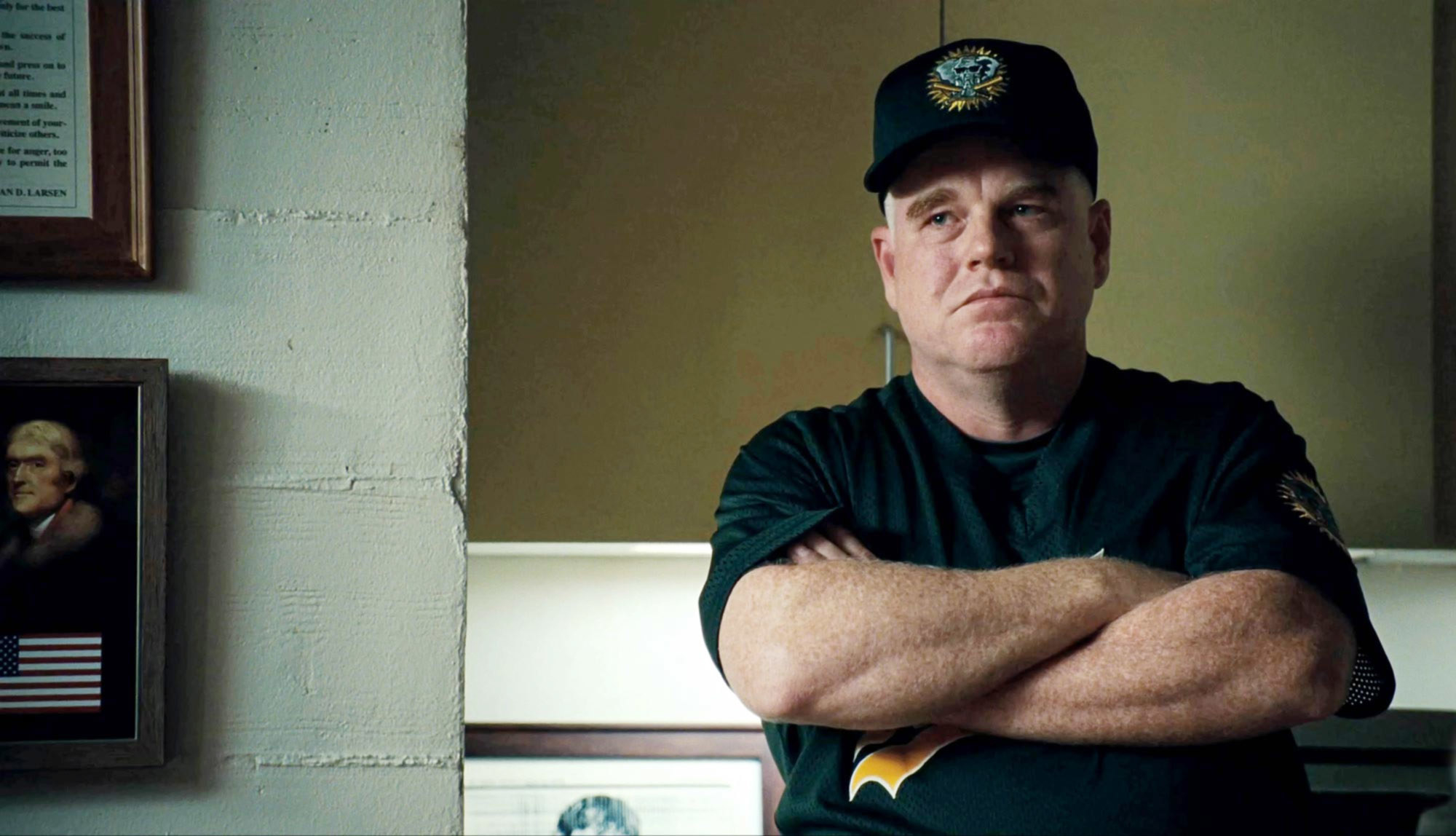 Phillip Seymour Hoffman as Howe, with his arms crossed