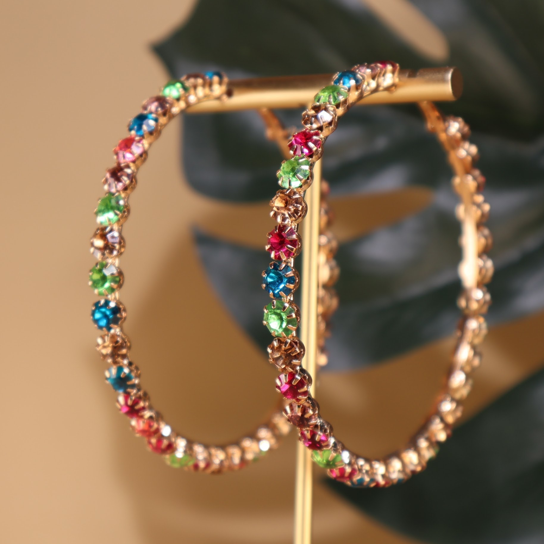 Hoop earrings with colorful gemstones.