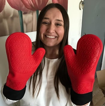 Reviewer wearing the red and black oven mitts