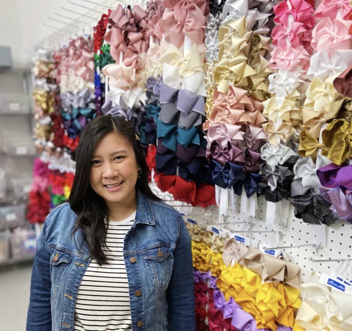 Woman standing in front of children's bows.
