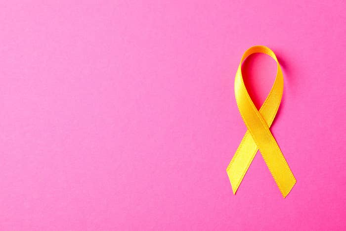 A yellow ribbon on a pink background