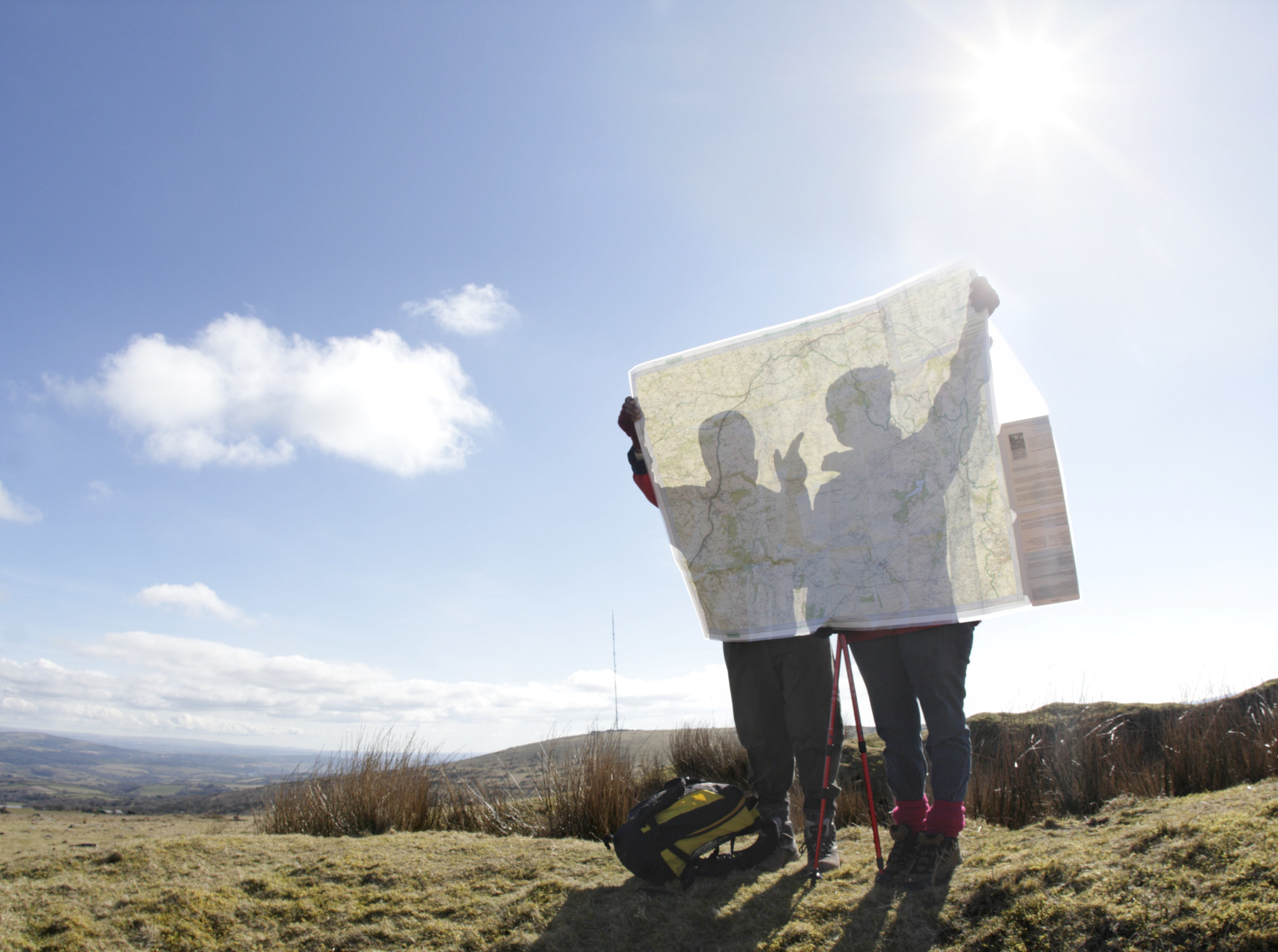 Two people looking at a map in a clearing