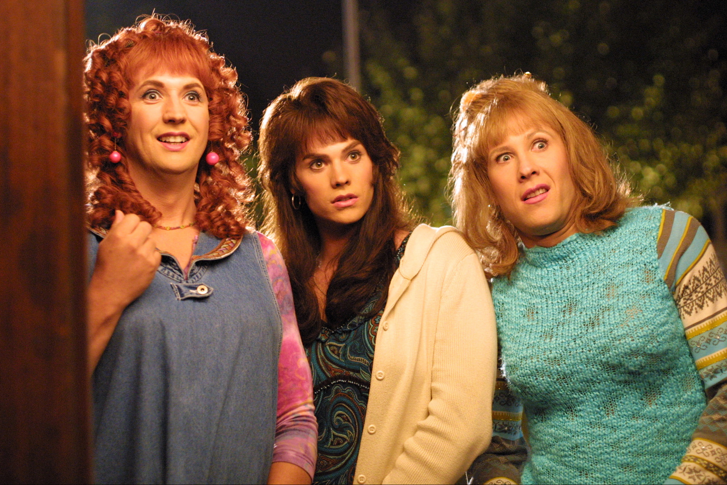 the three main characters dressed as women