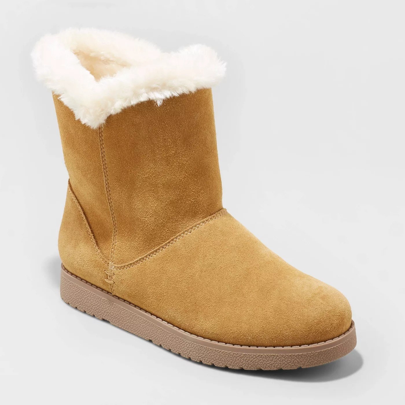 Light camel colored boots with off-white fur around the inside of the shoe