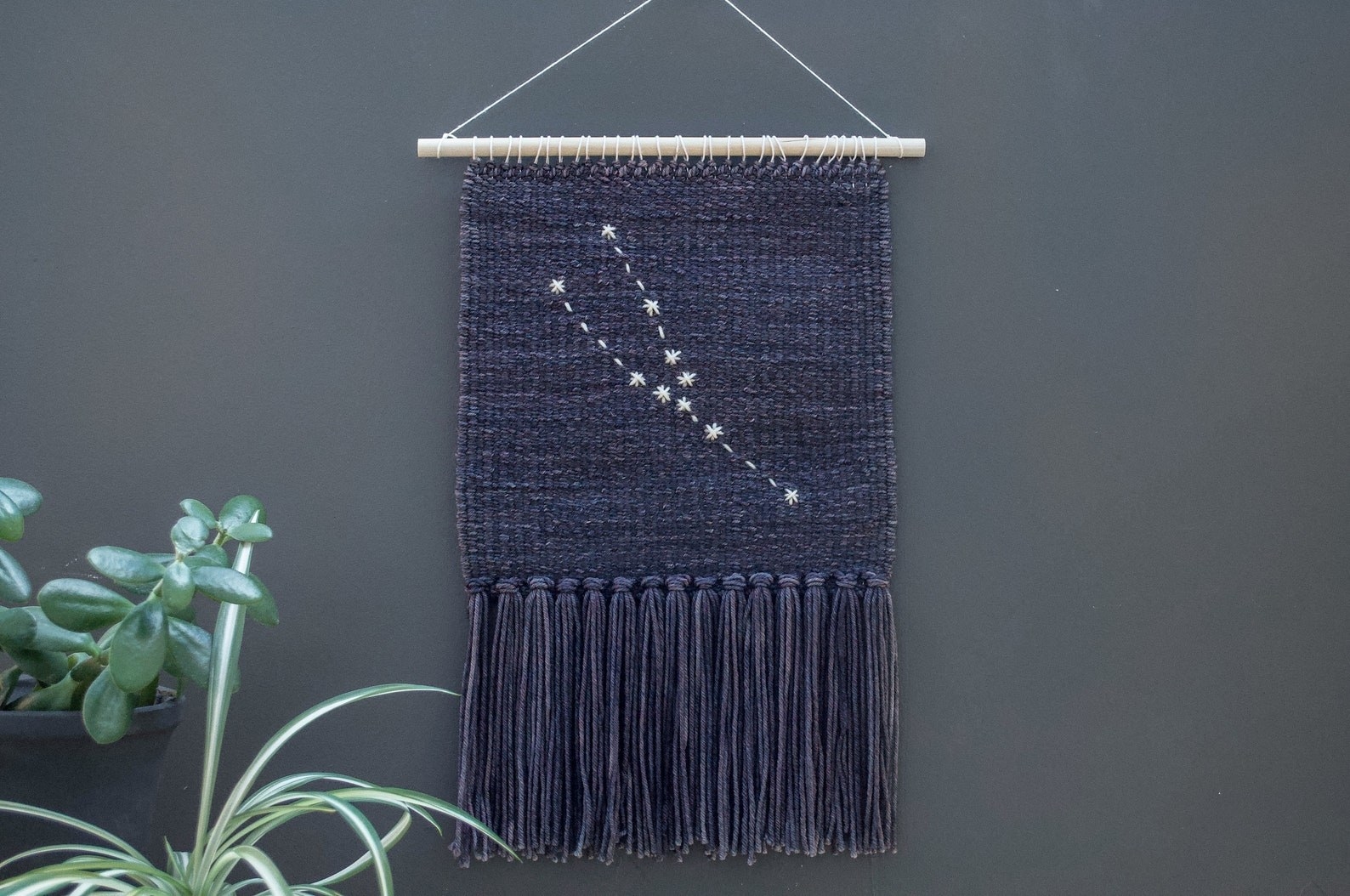 The Taurus wall hanging in black against a gray wall