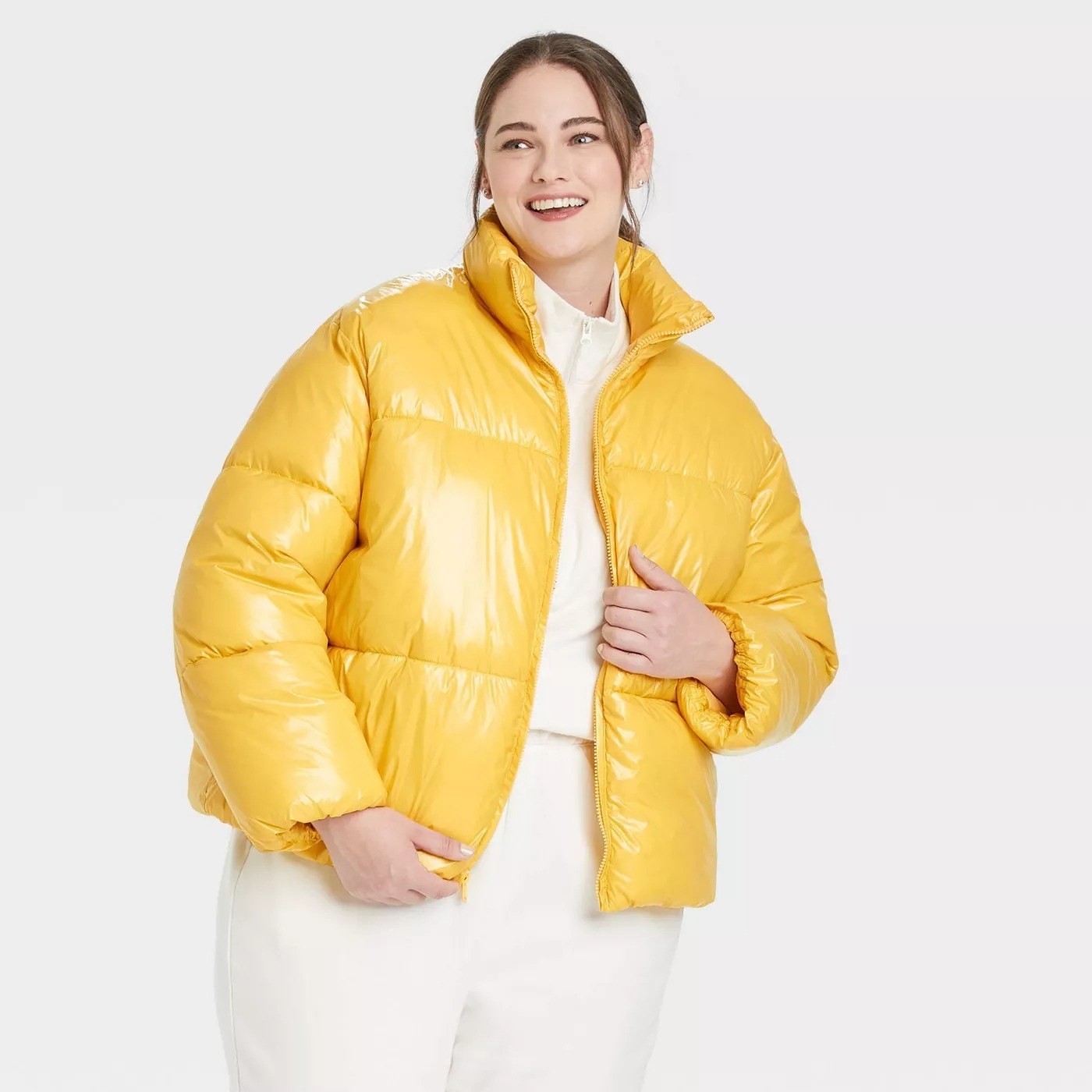 Model wearing yellow puffy jacket, goes past the waist