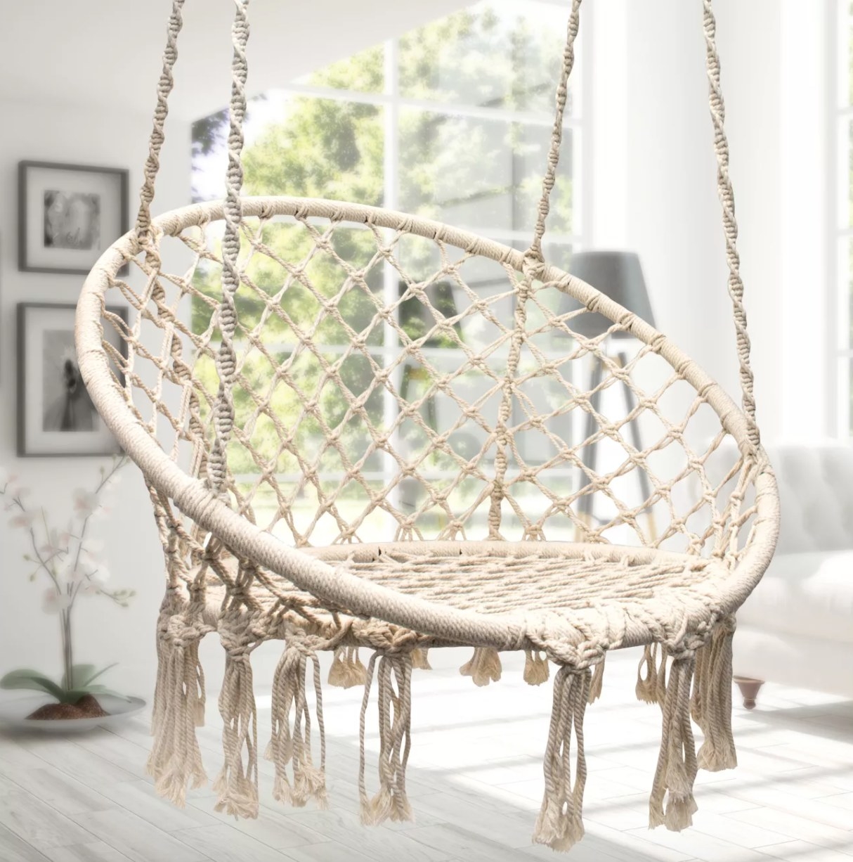 A white macrame hanging chair