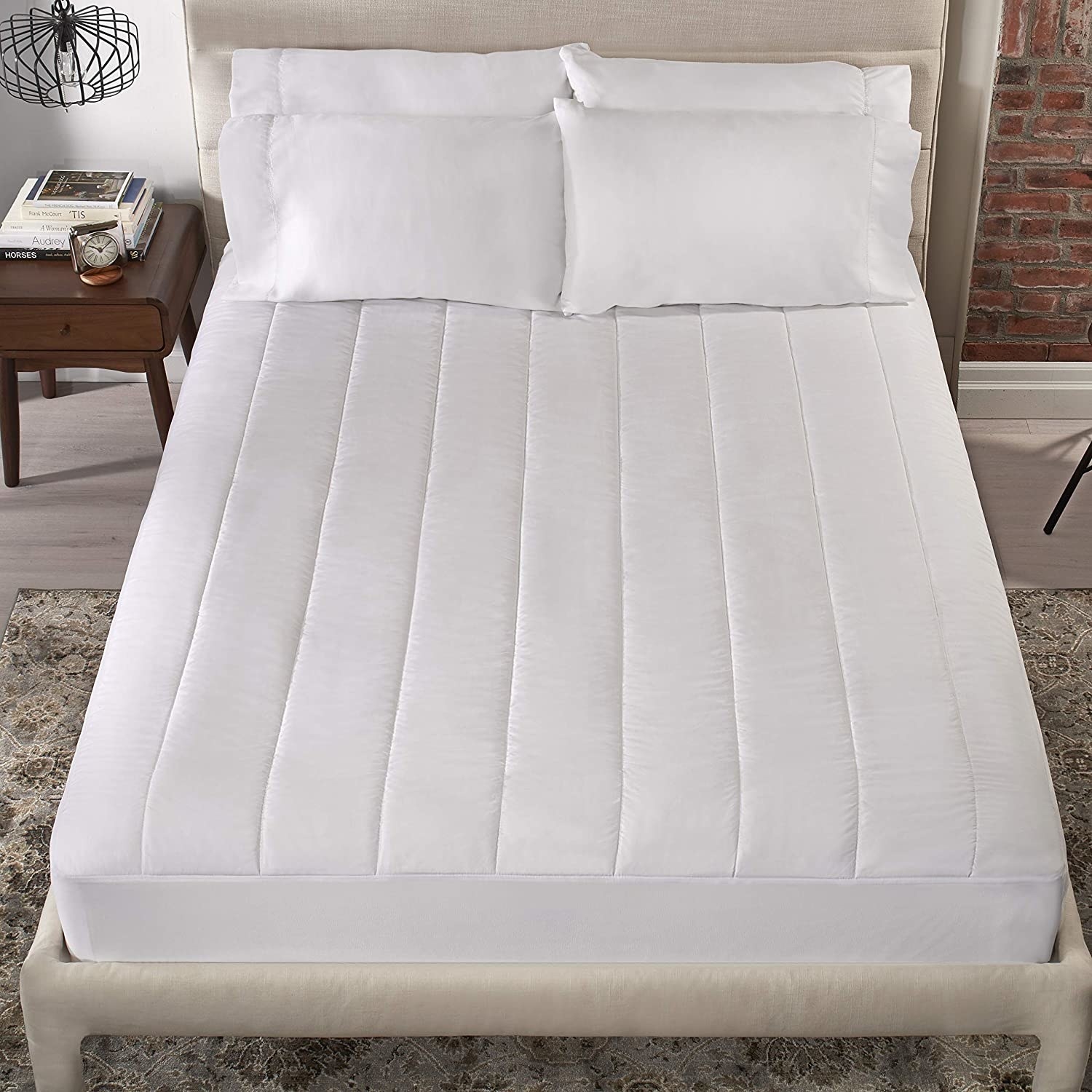 the quilted heated mattress pad on a bed